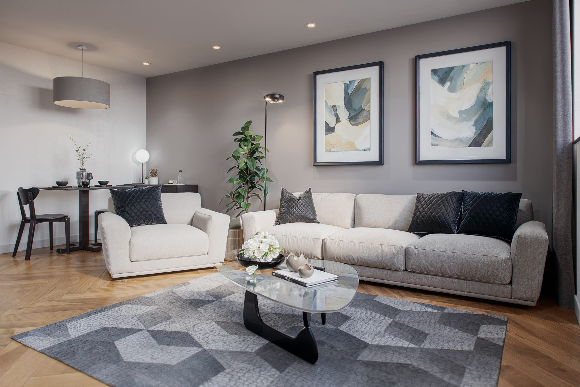The open-plan living space in an apartment at One Trafford Edge, with herringbone flooring